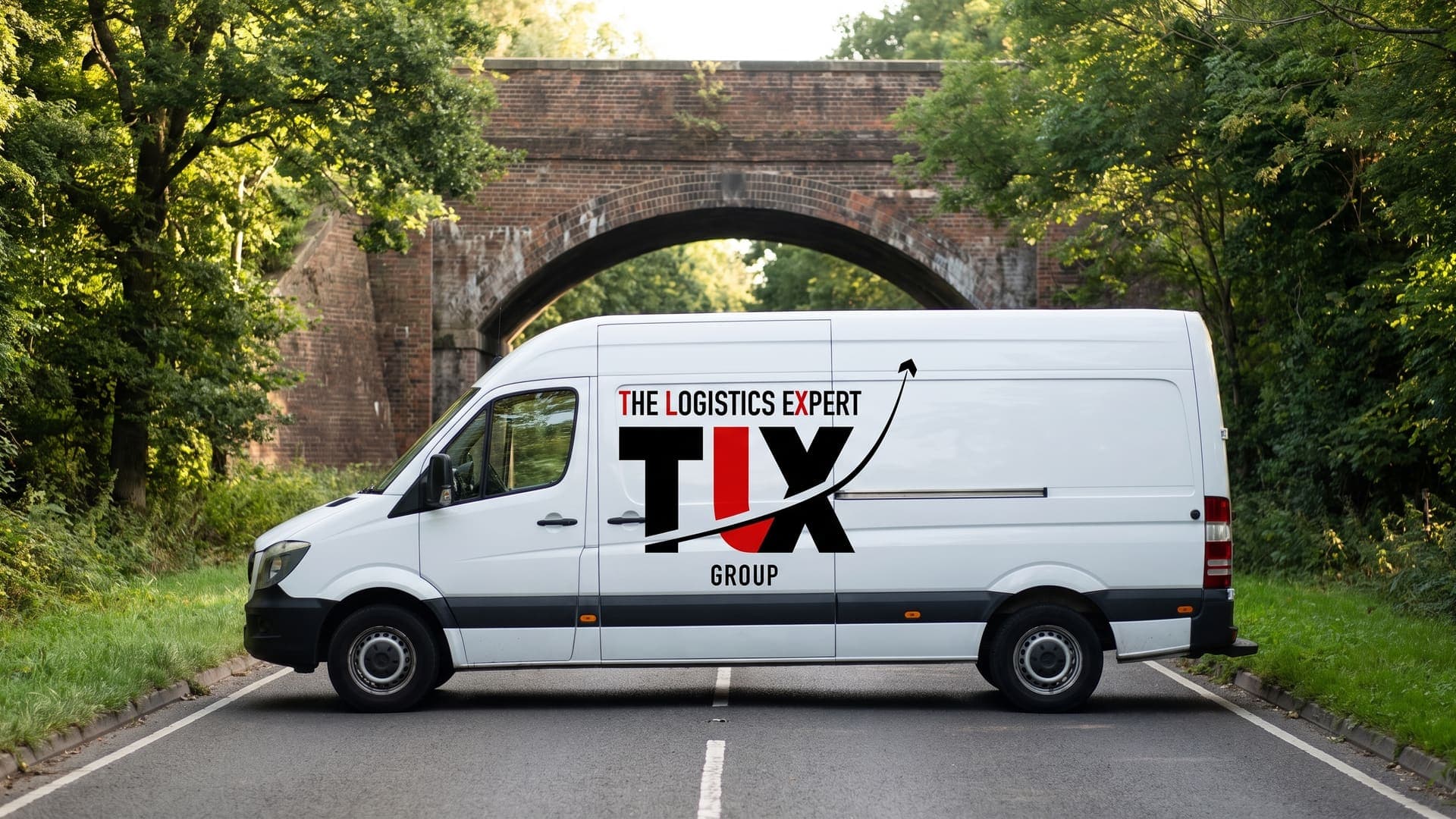 TLX Group van on a tree-lined A-road in the Home Counties