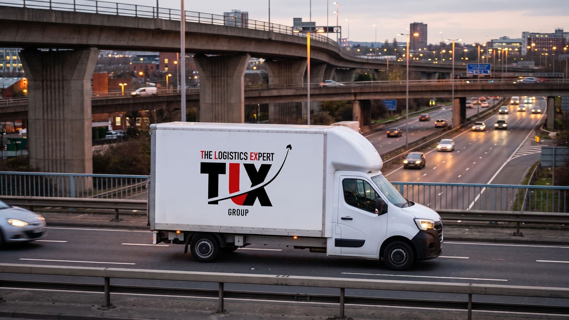 TLX Group Luton van on the M6 at Spaghetti Junction, Birmingham, at dusk