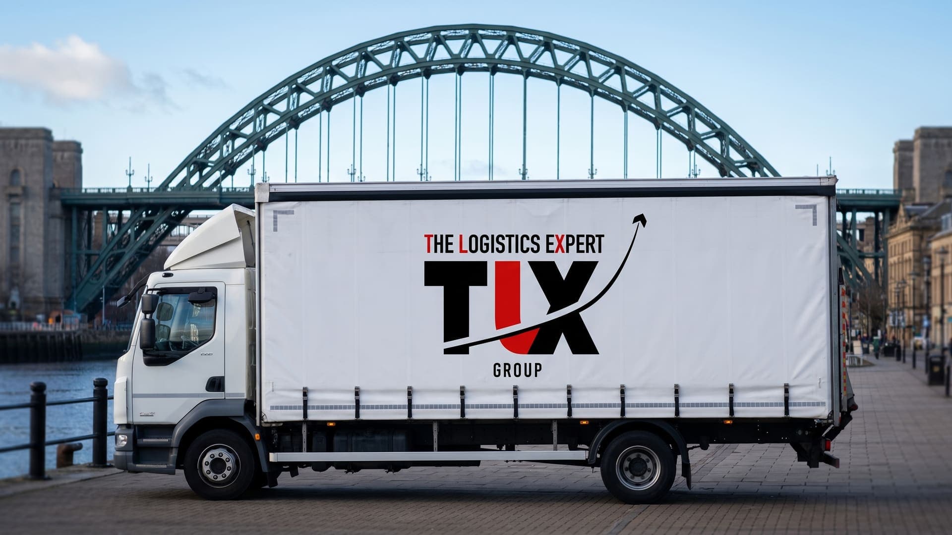 TLX Group curtain-sided truck on the Newcastle quayside with the Tyne Bridge behind
