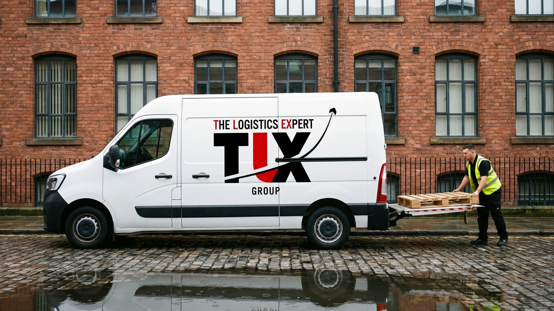 TLX Group van loading a pallet by tail-lift outside a Manchester mill