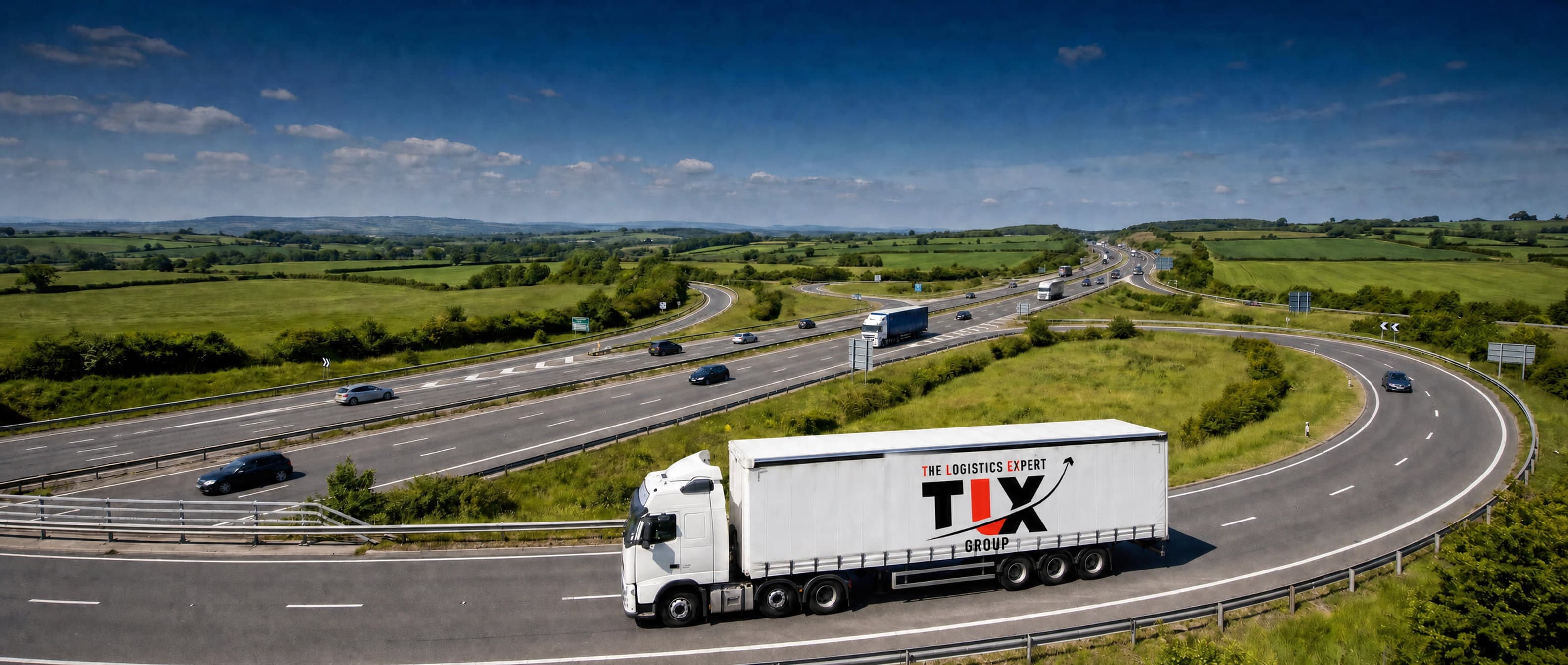 TLX Group articulated lorry on a motorway interchange in daylight