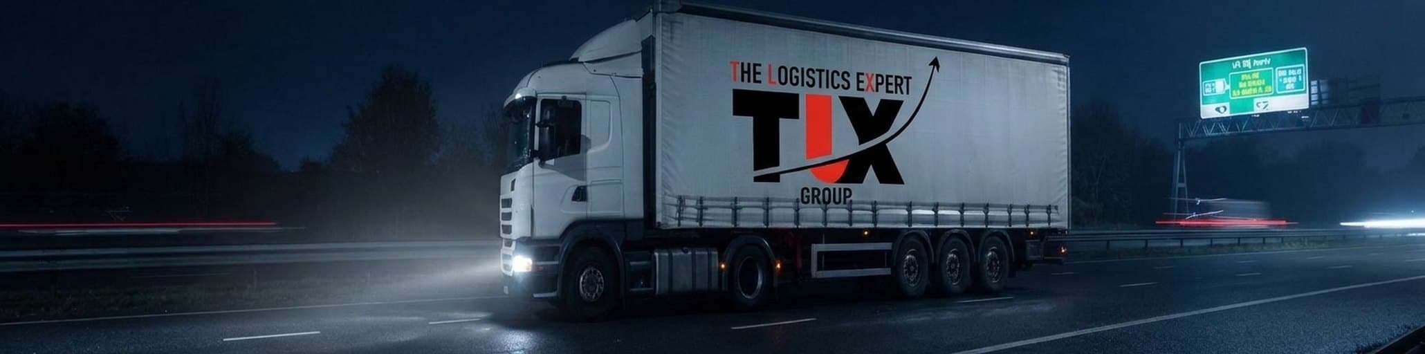 TLX Group articulated lorry on the motorway at night