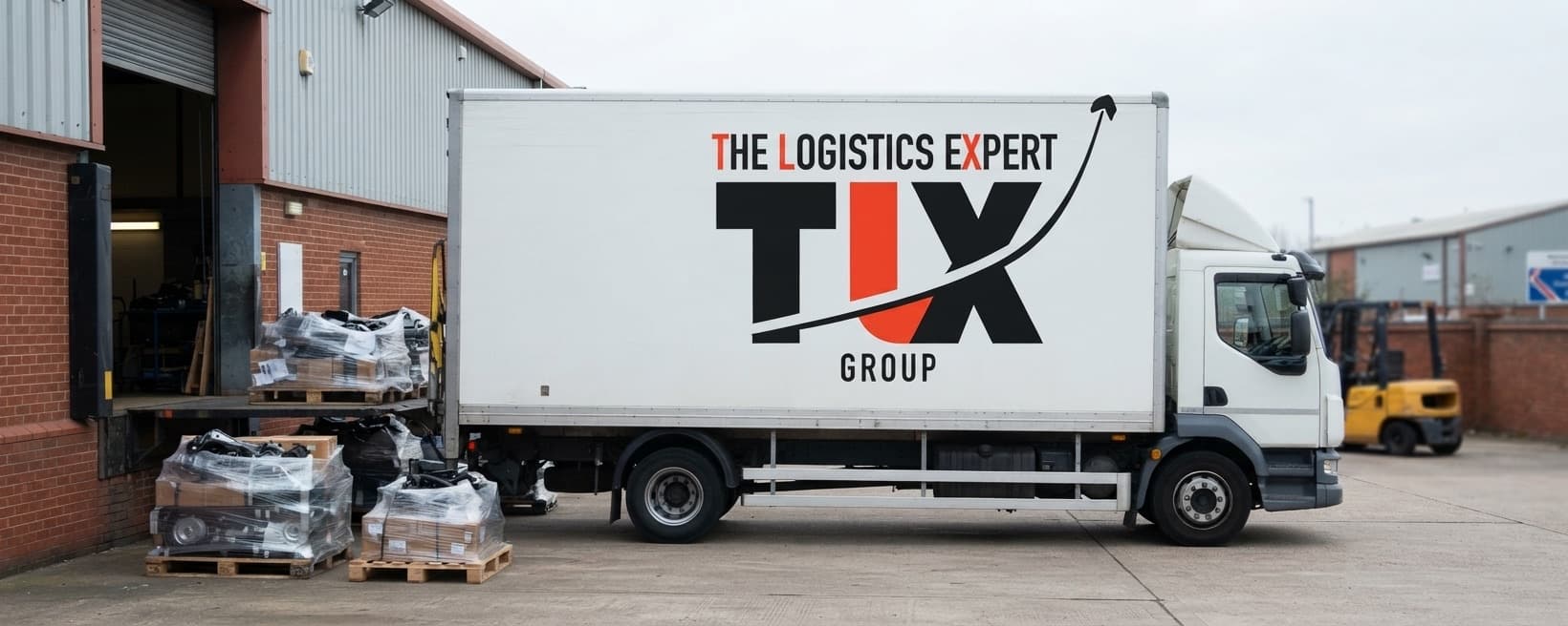 TLX Group 12 tonne truck loading palletised components at a factory bay