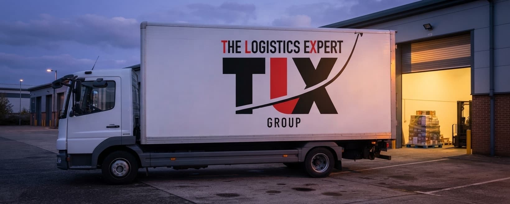 TLX Group 7.5 tonne truck outside an industrial unit at dusk